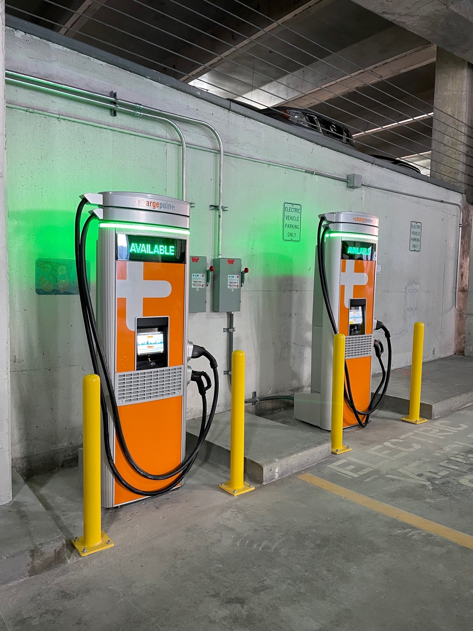 A pair of Electrical Vehicle charging stations in a city parking deck.