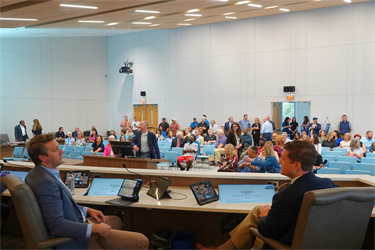 Councilmembers Luke Waddell Sr. and David Joyner chat attend of the first meeting inside the new Council Chambers
