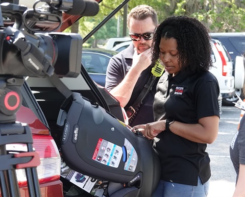 a technician installing a car seat