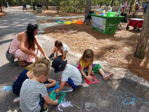 children playing with chalk in a park