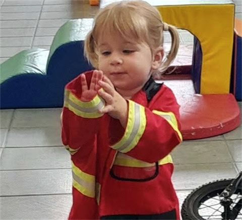 small child in fireman costume.png