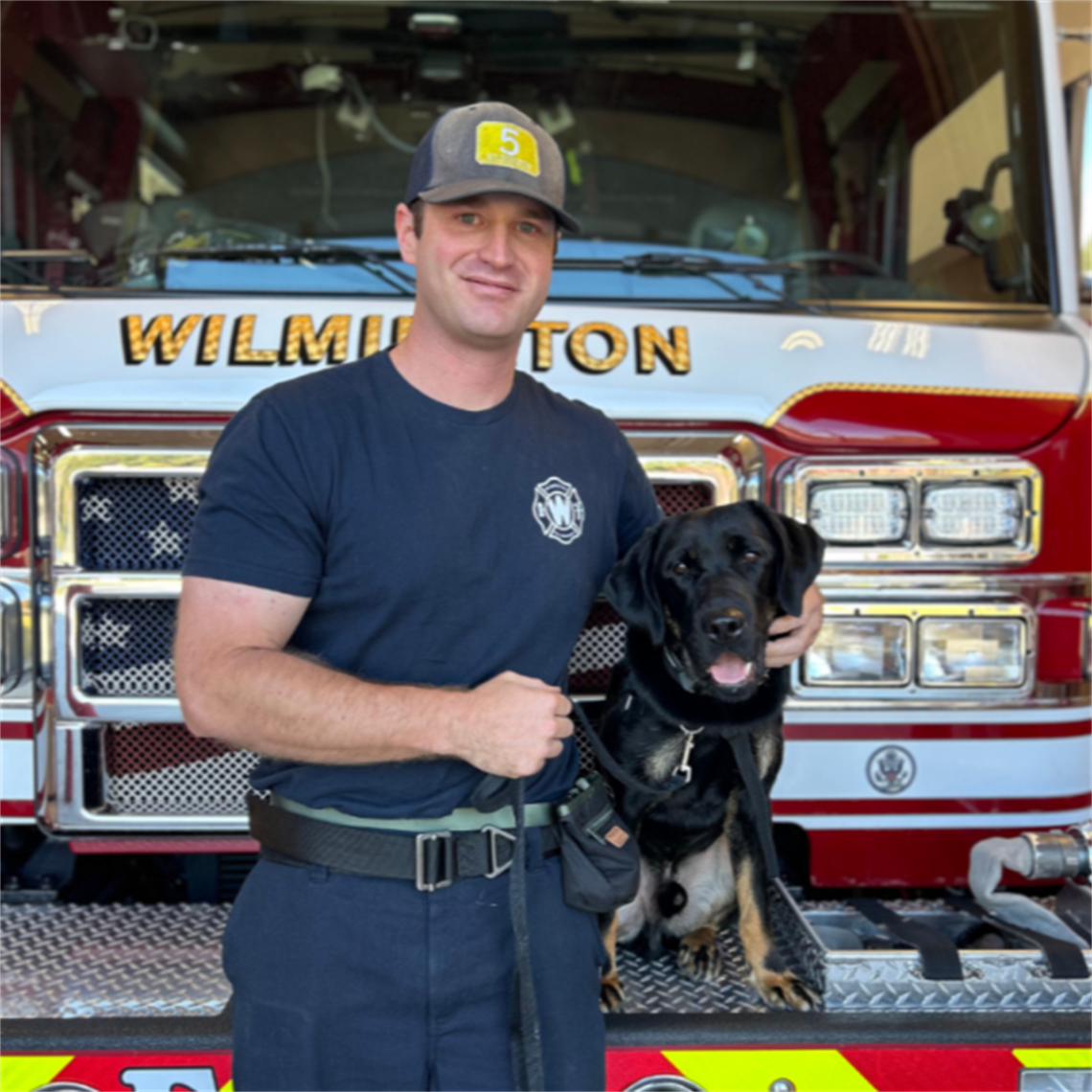 Firefighter Molinelli poses with Crisis Response Dog, LONDON.