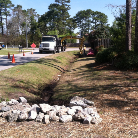 Workers in a stormwater ditch.