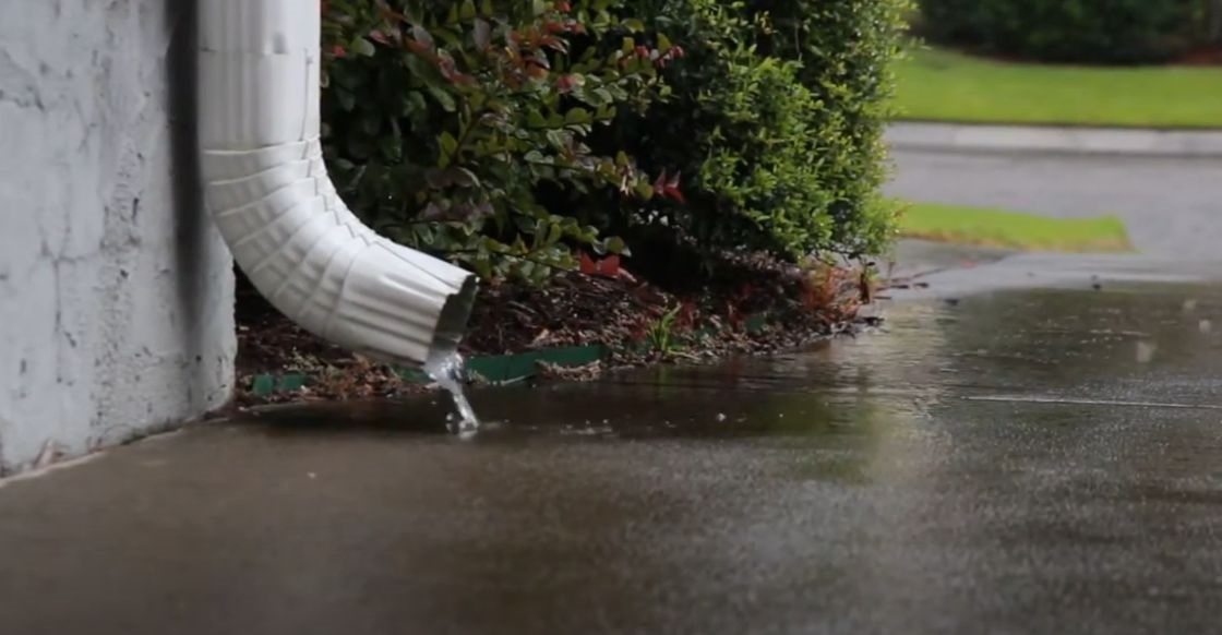Downspout draining to driveway