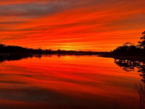 A bright red sunset over Hewletts Creek.